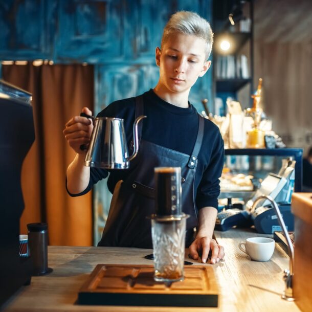 Barista Pours Water From Coffee Pot